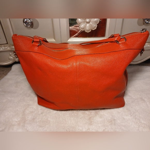 Coach Tyler Tote in an orange/red shade of pebbled leather. - Picture 2 of 16